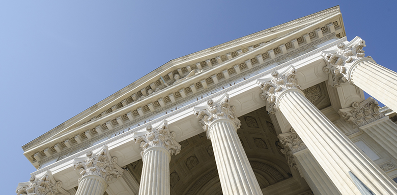 Looking up at a white stone court building